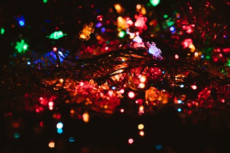 bright colored garlands bulb shines in the dark background,  selective focusの写真素材