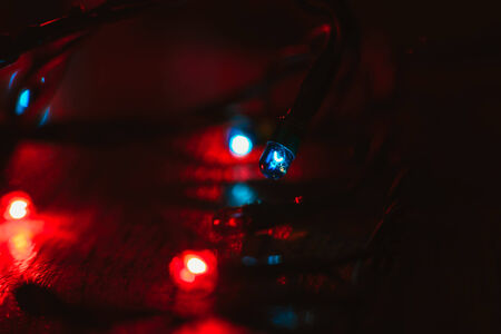 Christmas lights on wooden background.  Selective focus