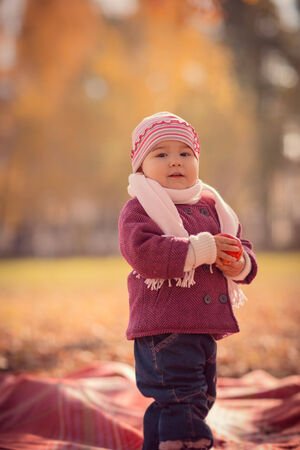 Beautiful outdoor autumn portrait of adorable  toddler girlの写真素材