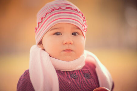Beautiful outdoor autumn portrait of adorable  toddler girlの写真素材