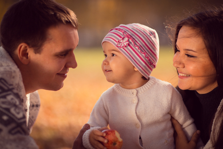 happy young family spending time  outdoor in the autumn parkの写真素材