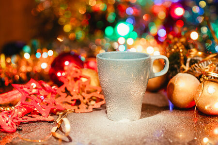 Cup of tasty hot cocoa, on wooden table,  on shiny backgroundの写真素材