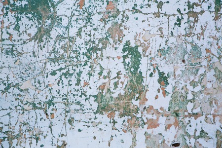 Grunge wall texture background.  Paint cracking off dark wall with rust underneath.の写真素材