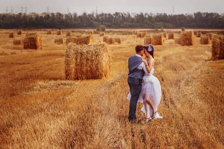 bride and groom near hay barnの写真素材