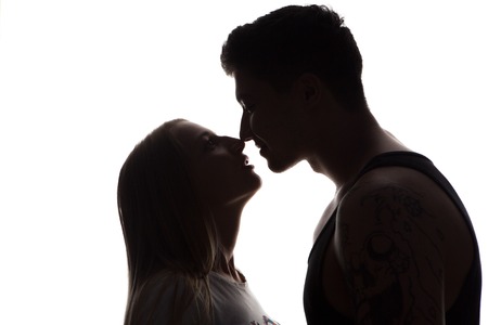 Passionate sensual attractive young couple in love, man caresses woman neck, isolated black  and white portraitの写真素材