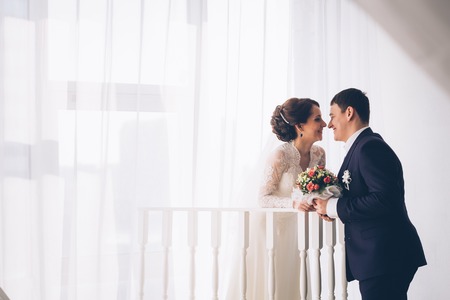 Portrait of Caucasian groom  and bride embracingの写真素材