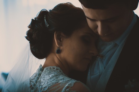 Portrait of Caucasian groom  and bride embracingの写真素材