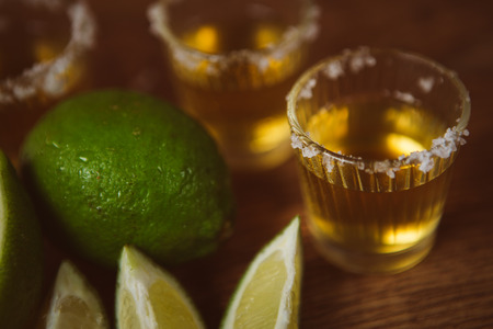 tequila , lime and salt on wooden  table selective focusの写真素材