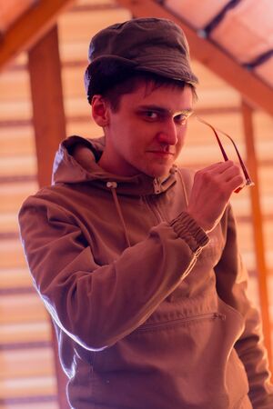 Man hipster wearing waxed canvas jacket with village backhroundの写真素材