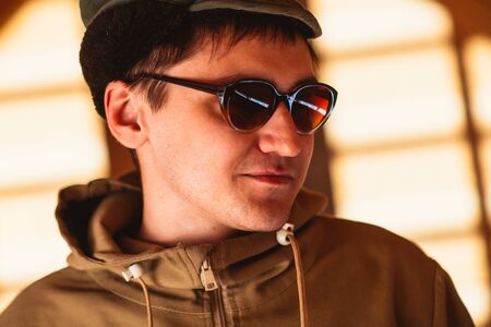 Man hipster wearing waxed canvas jacket with village backhroundの写真素材