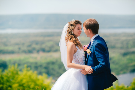 beautiful  young couple posing in the park on a background of natureの写真素材