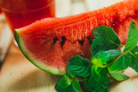 watermelon smoothie  and fresh on a light wood background. selective focus to mint
