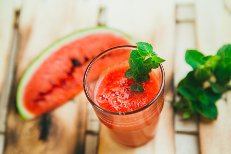 watermelon smoothie  and fresh on a light wood background. selective focus to mintの写真素材