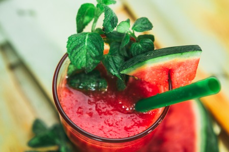 watermelon smoothie  and fresh on a light wood background. selective focus to mintの写真素材