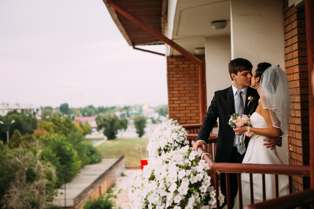 beautiful young  couple stand on the balconyの写真素材