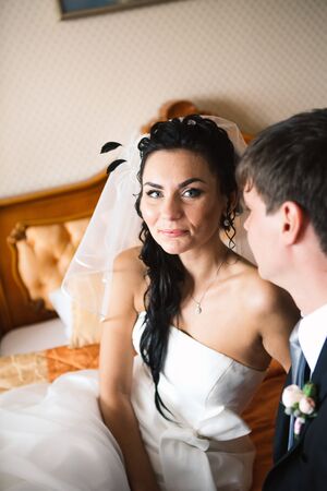 beautiful young  couple standing near the windowの写真素材