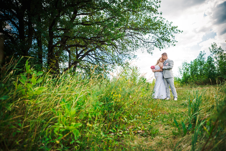 beautiful young couple stand on  background forestの写真素材