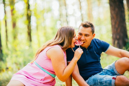 Romantic young couple kissing  on background summer forestの写真素材