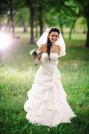 beautiful young bride stand on  background forestの写真素材