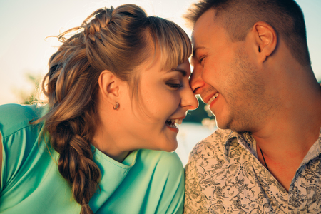 Romantic  couple sit and  kissing  on background summer lakeの写真素材