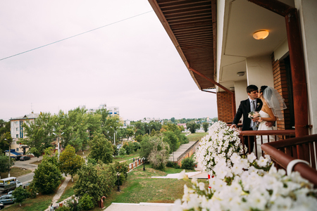 beautiful young  couple stand on the balconyの写真素材