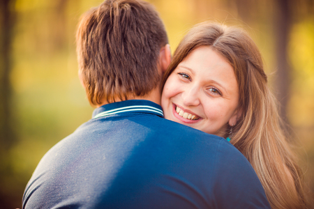 Romantic young couple kissing  on background summer forestの写真素材