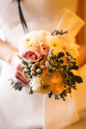 Beautiful wedding bouquet  of flowers in hands  the brideの写真素材
