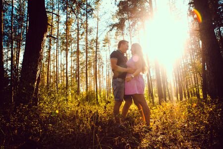 Romantic young couple kissing  on background summer forestの写真素材