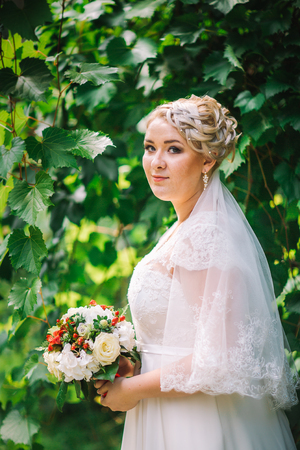 beautiful young bride stand on  background forestの写真素材