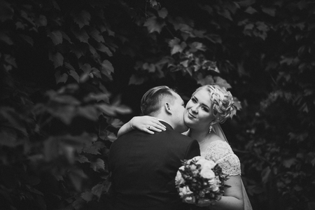 black and white  photo beautiful young couple stand on background forestの写真素材