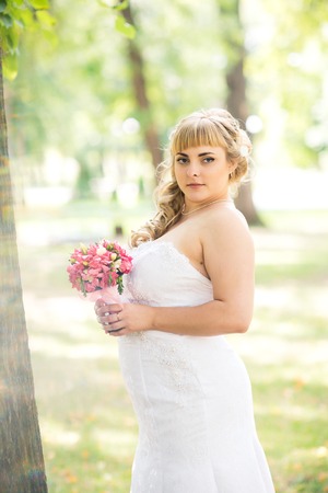beautiful young bride stand on  background forestの写真素材
