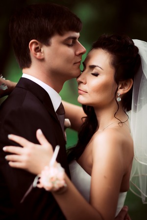 beautiful young couple stand on  background forestの写真素材