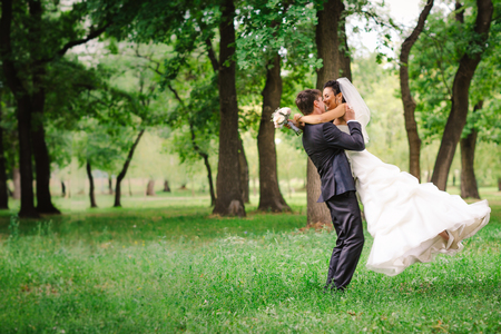 beautiful young couple stand on  background forestの写真素材