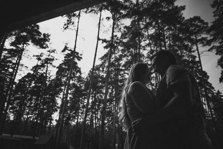 Romantic black and white photo young couple kissing on background summer  forestの写真素材