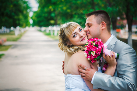 beautiful young couple stand on  background forestの写真素材