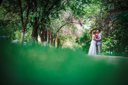 beautiful young couple stand on  background forestの写真素材