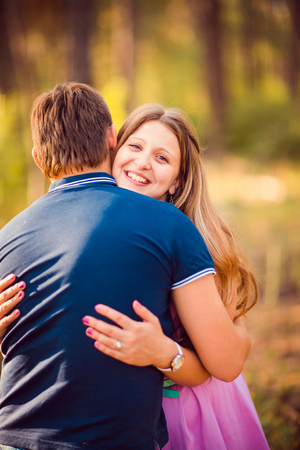 Romantic young couple kissing  on background summer forestの写真素材