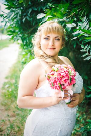 beautiful young bride stand on  background forestの写真素材
