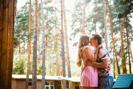 Romantic young couple kissing  on background summer forestの写真素材
