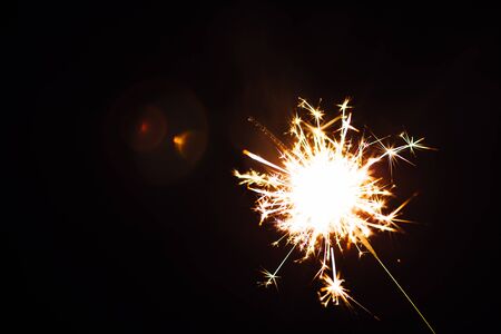 Bright Christmas  sparkler closeup on a black background soft focusの写真素材