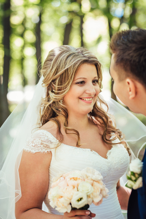 Happy couple bride and groom embracing they stand  in a forestの写真素材