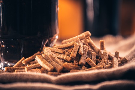 A glass of fresh beer and crackers on sackingの写真素材