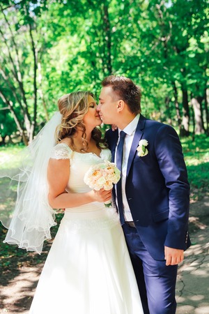 Happy couple bride and groom embracing they stand  in a forestの写真素材