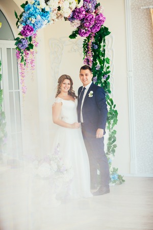 Bride and groom posing  in a hotel roomの写真素材