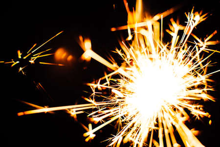 Bright Christmas  sparkler closeup on a black background soft focusの写真素材