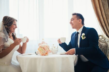 Bride and groom posing  in a hotel roomの写真素材