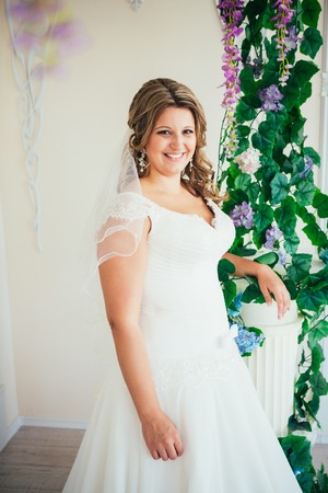 elegance cute  bride is posing on the  background roomの写真素材