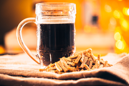 A glass of fresh beer and crackers on sackingの写真素材