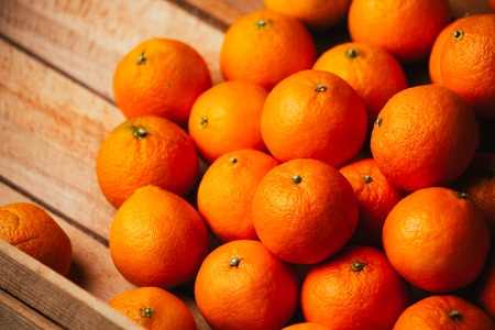 many fresh tangerines  on a wooden backgroundの写真素材