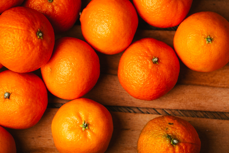 many fresh tangerines  on a wooden backgroundの写真素材
